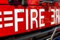 Large FIRE sign on front of British fire engine. Royalty Free Stock Photo