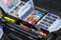 A large fisherman`s tackle box fully stocked with lures and gear for fishing.fishing lures and accessories in the box background Royalty Free Stock Photo