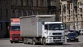 Large five-axle lorries drive along a city street. June, 12, 2021, Russia, Magnitogorsk. Urban