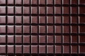 Large flat bar of dark chocolate squares with patterns.