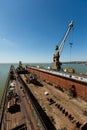 Large floating dock, maritime vessel repair station with crane on sunny day. Empty dry dock, sea industry infrastructure Royalty Free Stock Photo