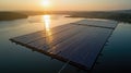 Large floating solar panel array generates renewable energy at sunrise, reflecting on calm water while surrounded by Royalty Free Stock Photo