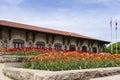 Large flowerbeds of orange and red tulips with the Mount-Royal Chalet in the background Royalty Free Stock Photo