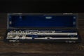 Large flute in a case on a wooden surface Royalty Free Stock Photo