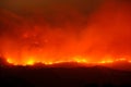 Large forest wildfire at night