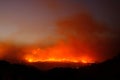 Large forest wildfire at night