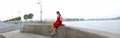 Girl in a red dress on the Palace embankment in St. Petersburg Royalty Free Stock Photo