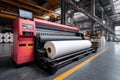 A large-format printer handles a massive roll of paper within an industrial setting, showcasing its precision and scale for Royalty Free Stock Photo