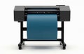 Large format printer with roll of blue paper sits on stand with wheels. Modern device used for printing large scale graphics. Royalty Free Stock Photo