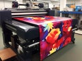 Large format printing machine in operation. Print on vinyl or paper or canvas Royalty Free Stock Photo