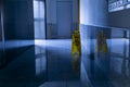 Large format shot of scrubbed marble floor with yellow CAUTION sign