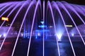 Large fountain installation in the center of Bucharest. Purple water jets. Impressive street show.