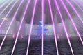 Large fountain installation in the center of Bucharest. Purple water jets. Impressive street show.