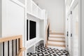 A large foyer with a white built-in storage unit and black and white tile flooring. Royalty Free Stock Photo