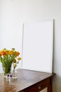 Large frame on used wooden table with buttercup flowers