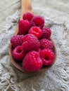 Large fresh red raspberry berries, poured into a wooden spoon Royalty Free Stock Photo