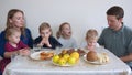 A large and friendly family has lunch at home. Royalty Free Stock Photo