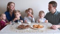 A large and friendly family has lunch at home. Royalty Free Stock Photo