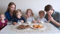 A large and friendly family has lunch at home. Royalty Free Stock Photo