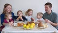 A large and friendly family has lunch at home. Royalty Free Stock Photo