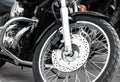 Large front wheel with many spokes. Beautiful spokes wheel bike. Close to monochrome photo. View of the bike from the front bottom Royalty Free Stock Photo