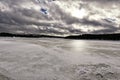 Large frozzen lake with forests around