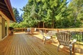 Large frsehly painted new wooden deck with nice summer green backyard. Royalty Free Stock Photo