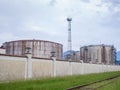 Large fuel tanks. Tanks and ladders of the tank farm. The gloomy atmosphere of an industrial area Royalty Free Stock Photo