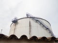 Large fuel tanks. Tanks and ladders of the tank farm. The gloomy atmosphere of an industrial area. Oil storage Royalty Free Stock Photo