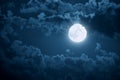 A Large Full Moon Breaks Out of the Clouds At Midnight Royalty Free Stock Photo