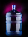 Large gallon of water on black background with pink tints