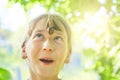 A large garden grape snail crawls over the girl`s face Royalty Free Stock Photo