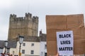 A large gathering of protesters kneel around the Obelisk at a Black Lives Matter protest in Richmond, North Yorkshire, with Royalty Free Stock Photo