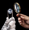Large gemstone and loupe in jeweler`s hands close up. Gem identifying and evaluating process