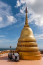 A large gilded Buddhist stupa against the sky on a high mountain near the Tiger Cave temple in Krabi province Thailand Royalty Free Stock Photo