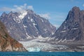 Large glacier flowing down mountain side to the sea at Evighedsfjord, Greenland Royalty Free Stock Photo
