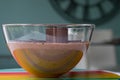 Large glass bowl of chocolate mousse standing on colourful glass platter, decorated with chocolate shavings and curls. Royalty Free Stock Photo