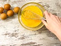 A large glass bowl with a process of beating eggs for cooking. Royalty Free Stock Photo
