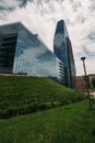 Large glass building large glass building in the foreground green grass in the background blue sky and cloud Royalty Free Stock Photo