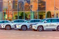 A large glass car dealership selling Lexus cars in the rays of the setting sun