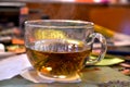 A large, glass cup with very hot Chinese, floral, bound tea