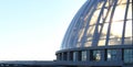 Large glass dome against a light sunset sky. Modern architecture. Fragment of a building close-up Royalty Free Stock Photo