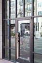 Large glass door with wooden bar handle at Starbucks Reserve upscale coffee shop located in Legacy West in Plano, Texas, USA