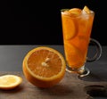 Large glass with a handle filled with lemonade with slices of orange and lemon