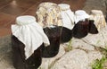 Large glass jars with sugar soaked sour cherries for alcohol fermentation Royalty Free Stock Photo