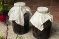 Large glass jars with sugar soaked sour cherries for alcohol fermentation Royalty Free Stock Photo