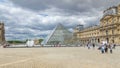 The large glass pyramid and the main courtyard of the Louvre Museum timelapse . Paris, France Royalty Free Stock Photo