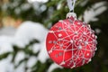 Large glass red ball with a pattern. Christmas tree toy on the tree Royalty Free Stock Photo