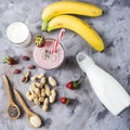 A large glass of strawberry-banana smoothie with ingredients Royalty Free Stock Photo