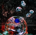 Large glass transparent ball inside the water with air bubbles a